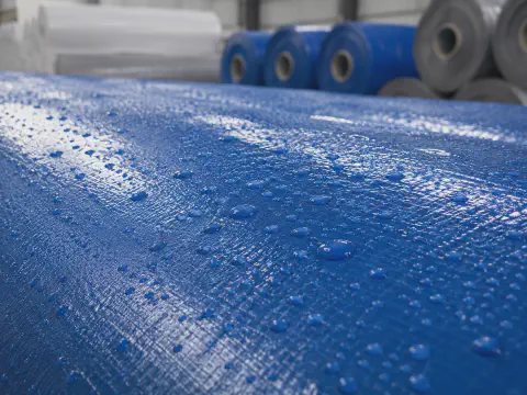 Water resistant laminated construction cover fabric for temporary site protection