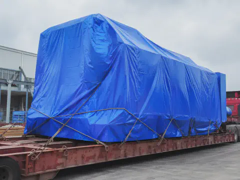 Blue tarpaulin cover protecting cargo on a flatbed truck