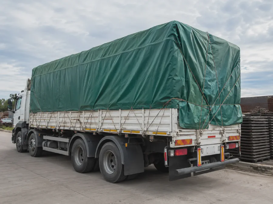 Green tarpaulin truck cover for outdoor cargo rain protection