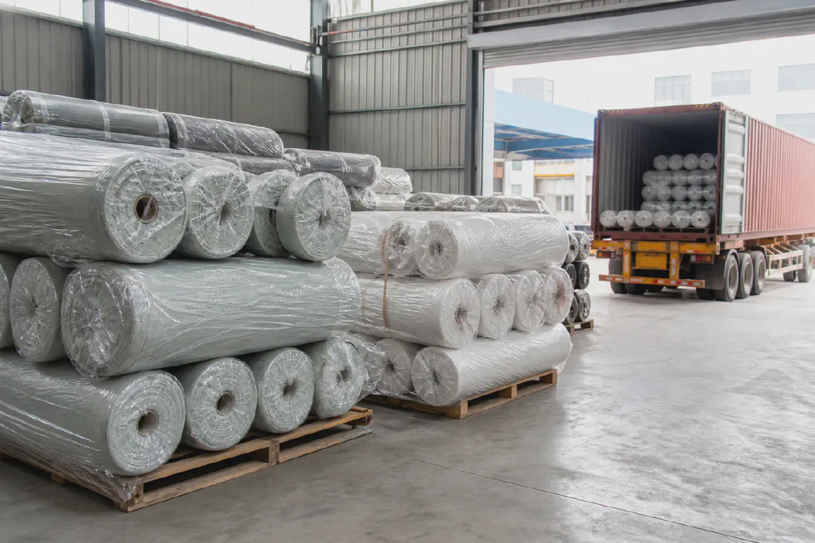 Export warehouse of packed woven fabric rolls