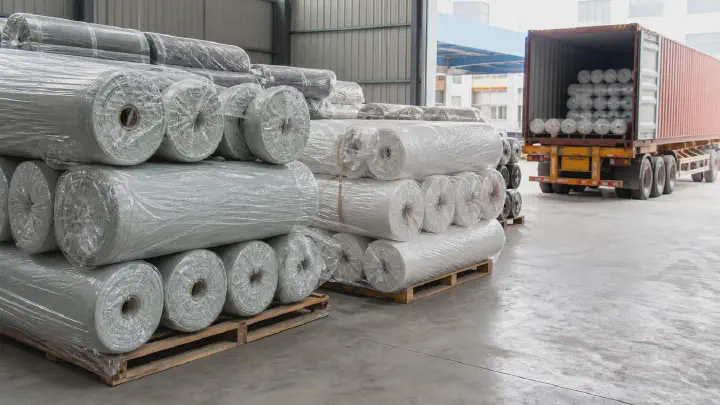 Export warehouse of packed woven fabric rolls