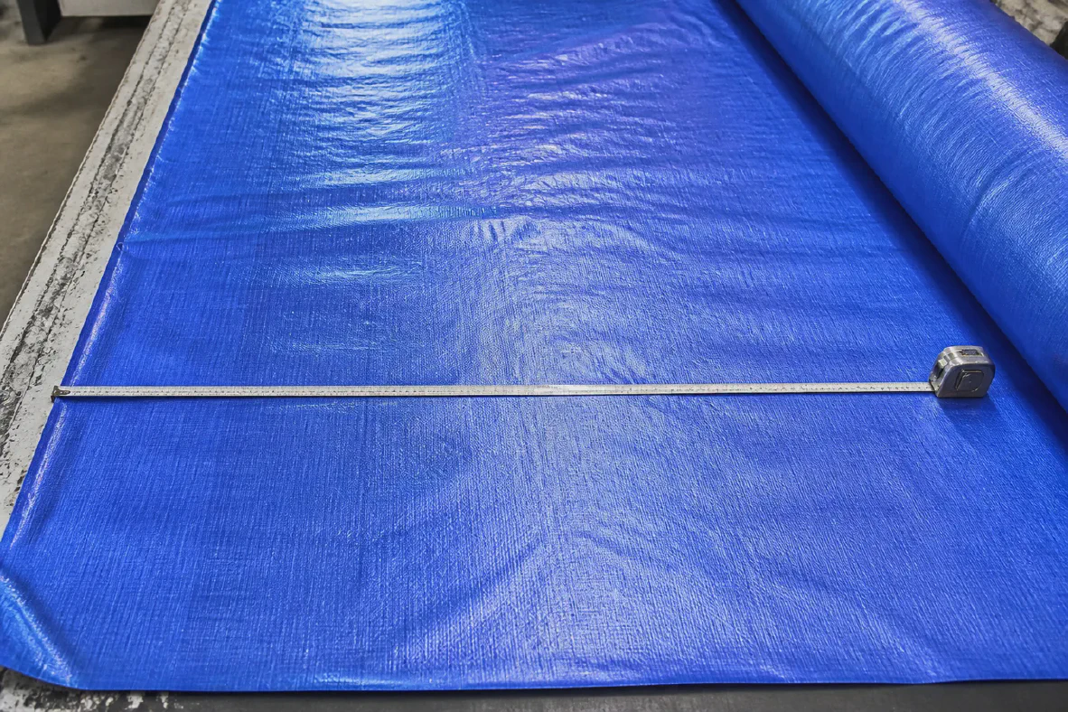 Measuring cutting width on laminated tarpaulin fabric