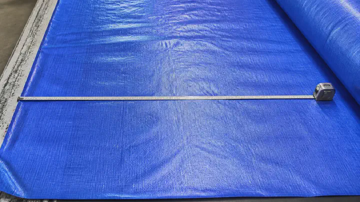 Measuring cutting width on laminated tarpaulin fabric
