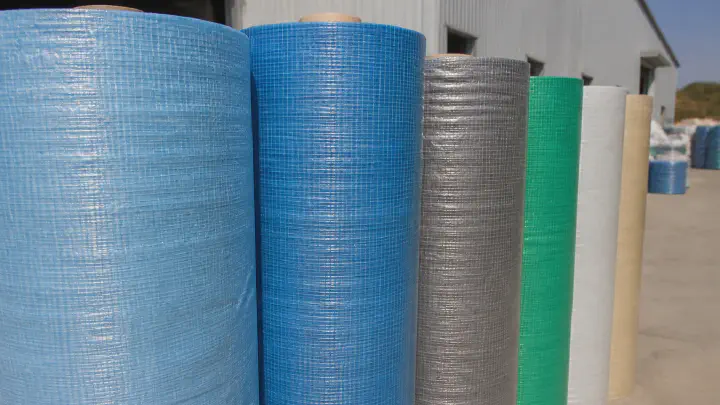 Laminated woven tarpaulin rolls stored in sunlight