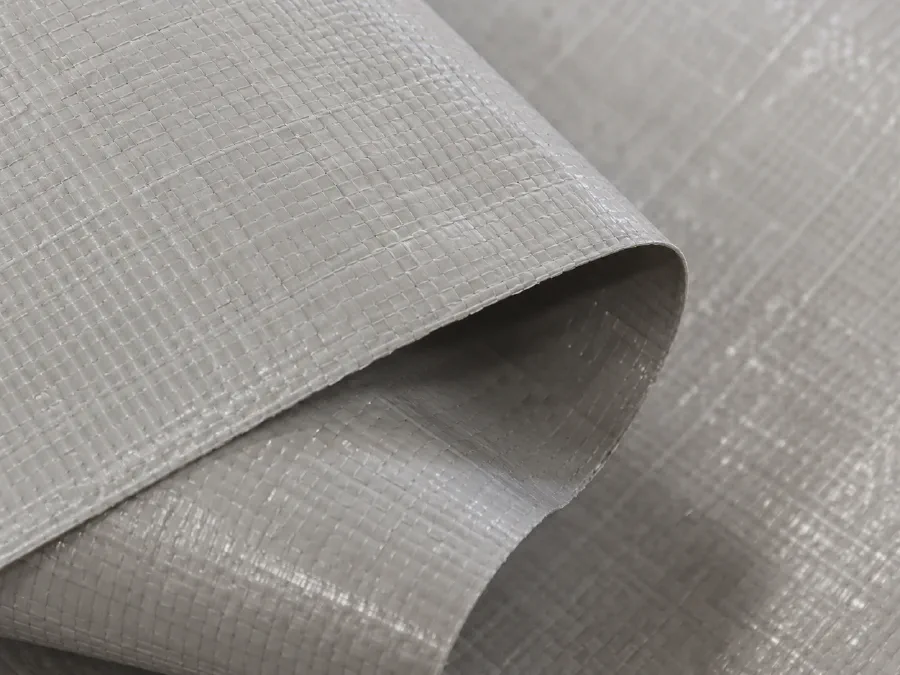 Close-up texture of white PP PE woven roll for packaging conversion